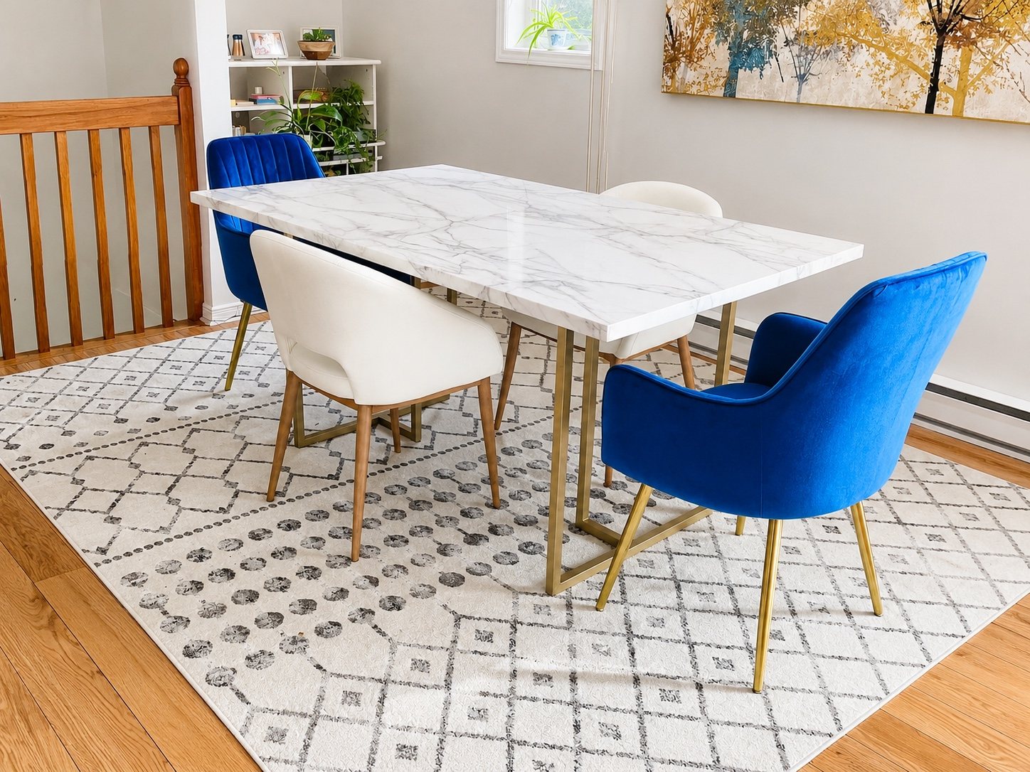 Dining room with marble-look table, blue chairs and neutral geometric rug