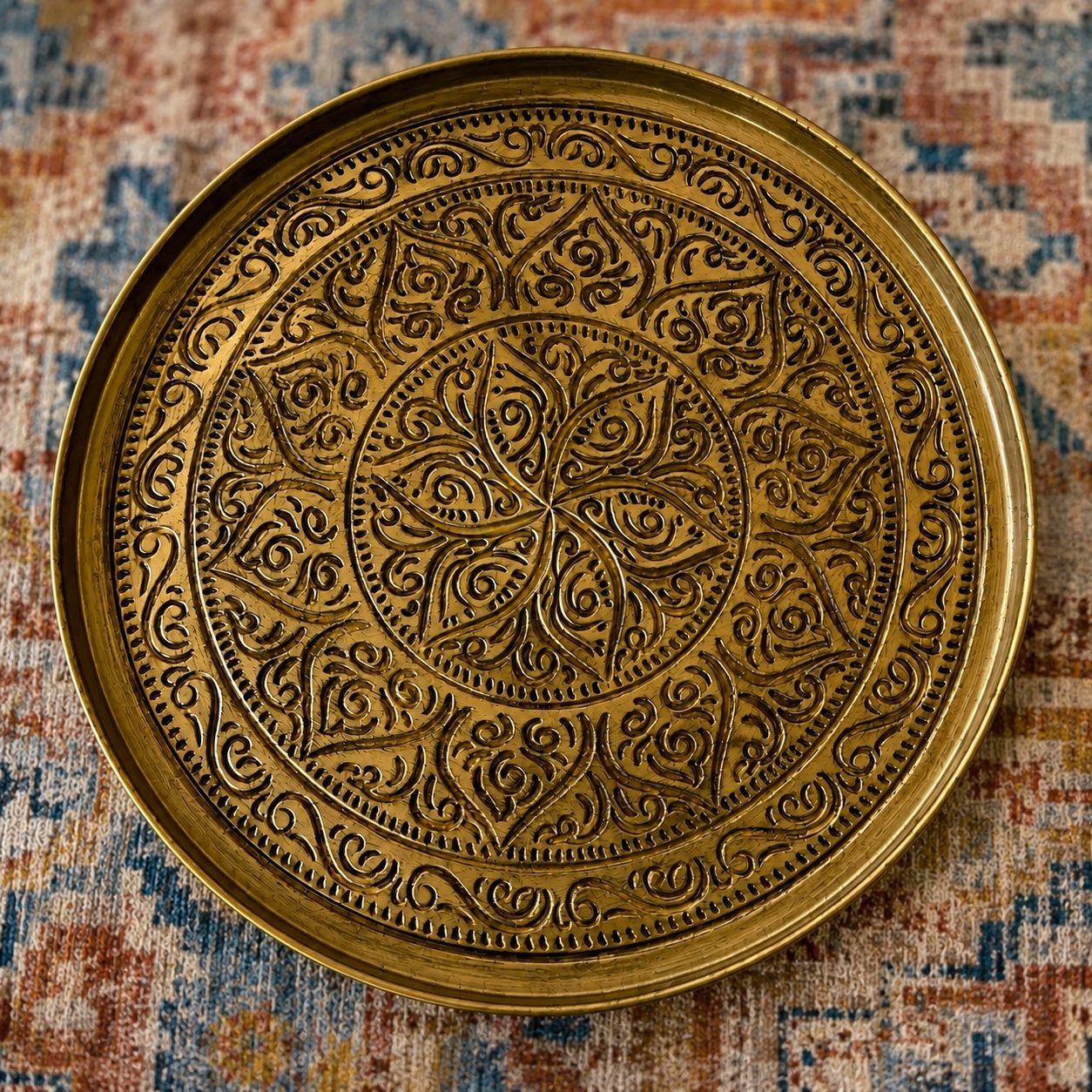 Close-up of ornate brass tray table on a patterned rug